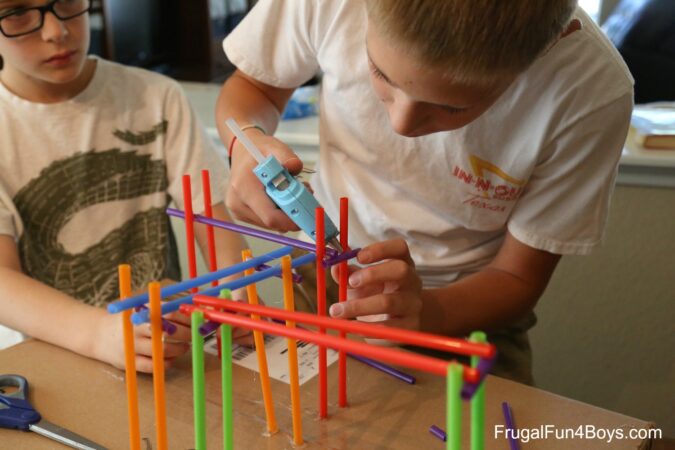 Boys building roller coaster from Tinker Toys as an example of fun last day of school activities