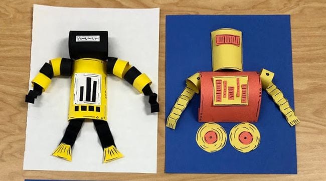 Colorful paper robots mounted on construction paper