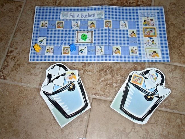 Bucket filler board game with large paper buckets and blue and white checkered game board