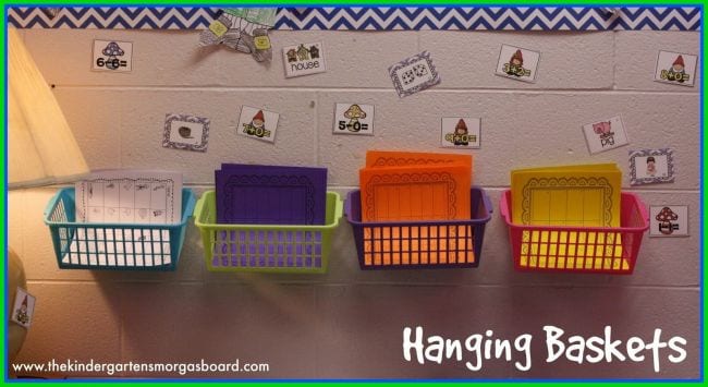 Four plastic baskets are attached to a wall and used as classroom cubbies.