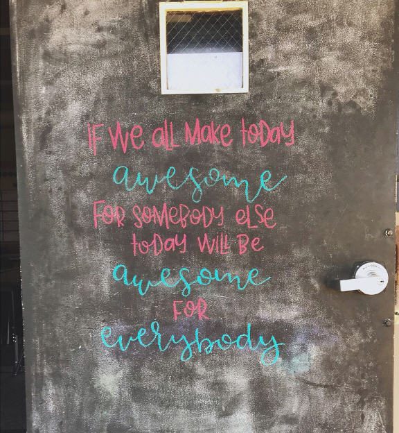 Classroom door painted with chalkboard paint. Text reads If we all make today awesome for somebody else, today will be awesome for everybody.