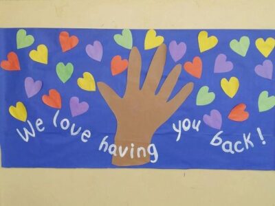We love having you back hand throwing colorful hearts back to school bulletin board idea