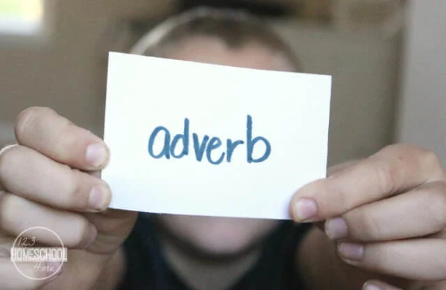 A boy holds up a card with the word 