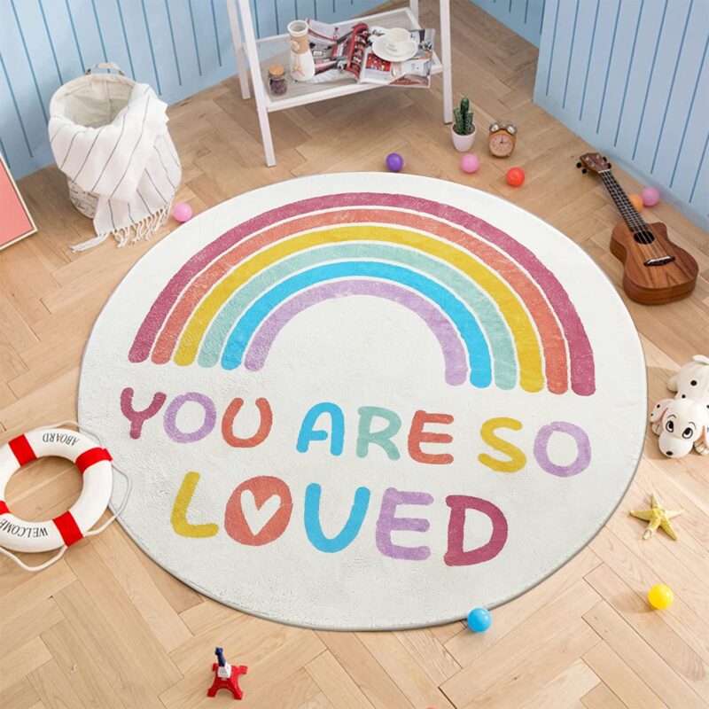 A round rug features a rainbow and the message You are So Loved.