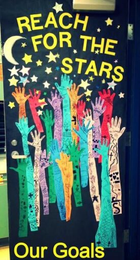 reach for the stars diy classroom door with hand cut outs and stars