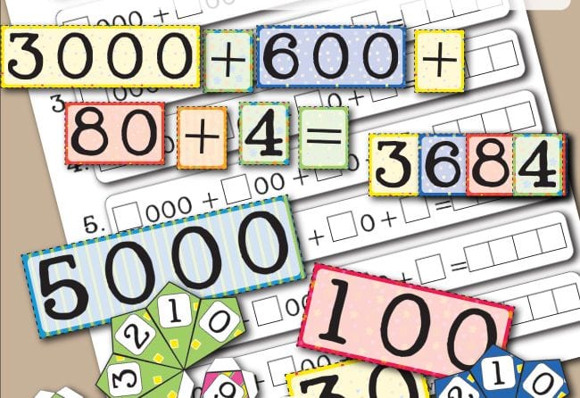 Colorful cards showing numbers laid out in expanded form, used for fourth grade math games