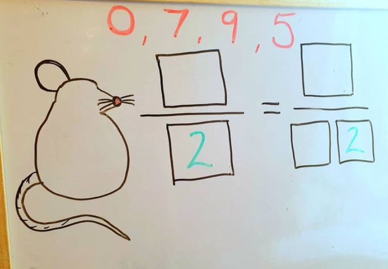 Rat shape drawn on a whiteboard next to two equivalent fractions with empty boxes for each number