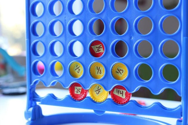 Connect Four set repurposed with fractions written on the checkers