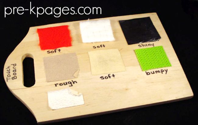 Wood cutting board with fabrics of different textures glued to it (Five Senses Activities)