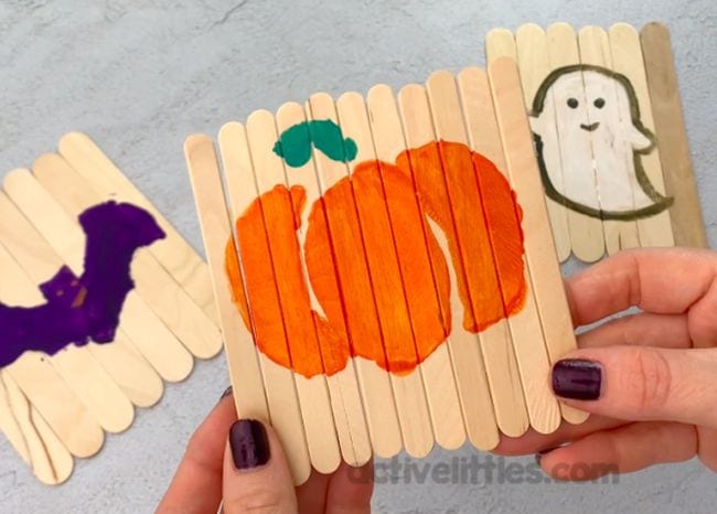 A puzzle made from craft sticks with a pumpkin painted on it