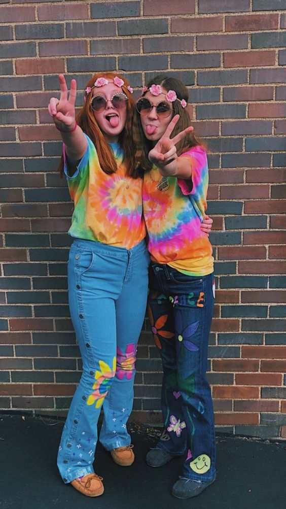 Teacher Halloween costumes include two women shown dressed in tie dye shirts, flower crowns, and sunglasses