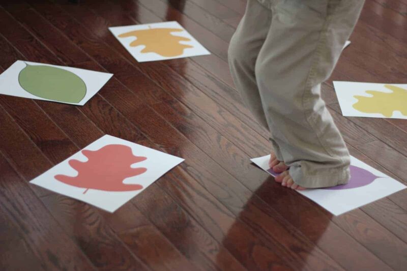 child stomping on leaf pictures for fall activities