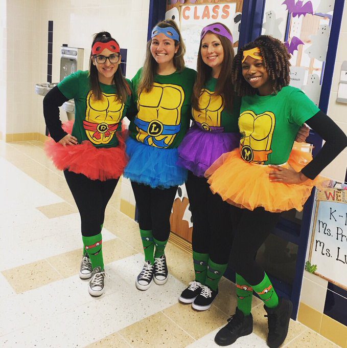 Several female teachers are dressed up like ninja turtles.