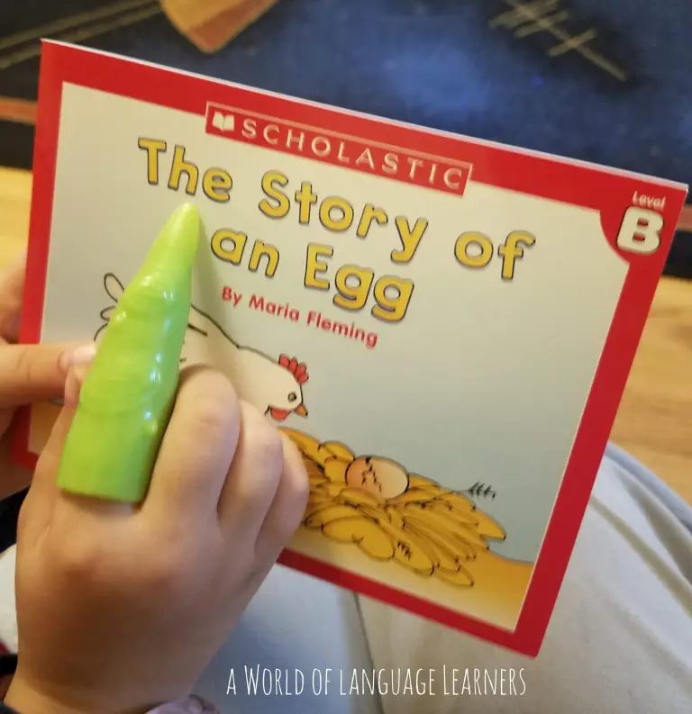 student pointing to the word on a book 