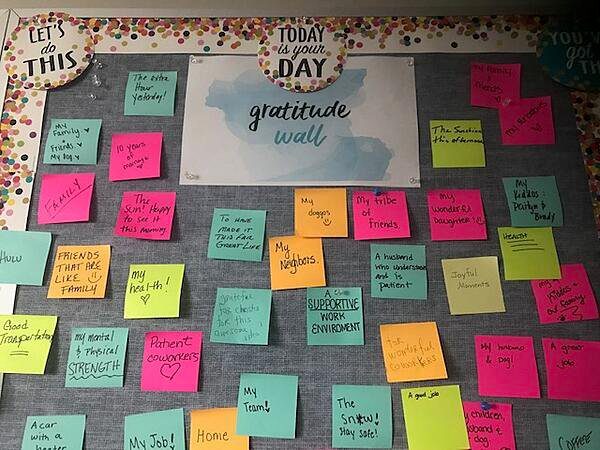 A wall with post its is shown. The notes contain things the students are grateful for.