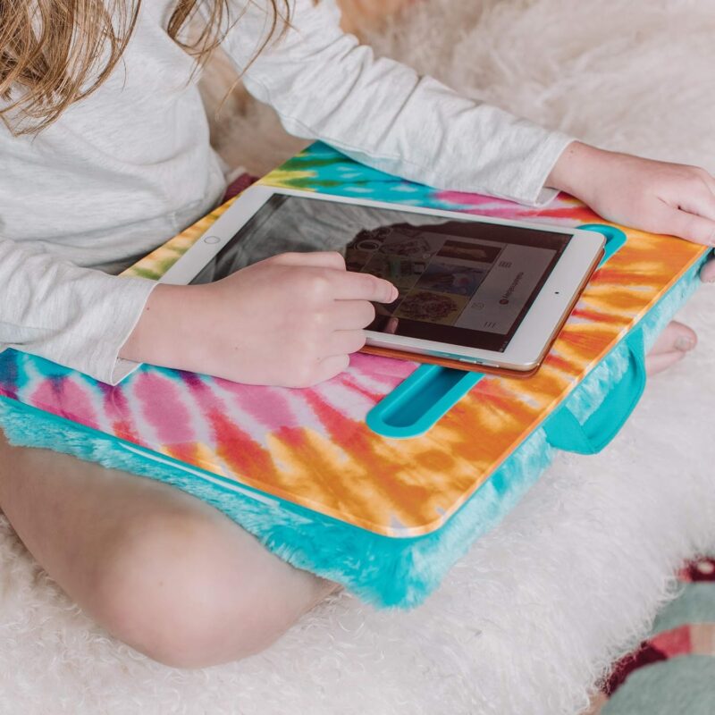 Students with anxiety, like this one shown sitting cross legged from the waist down, can benefit from a weighted lap desk like this tie-dye one.