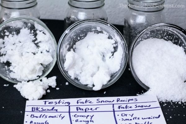 3 jars filled with white artificial snow, with paper reading Testing Fake Snow Recipes