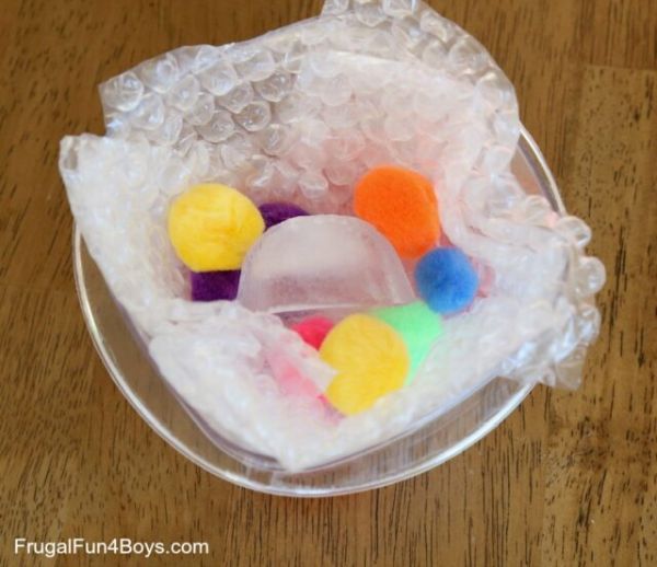 Colorful ice cubes sitting in a bowl with bubble wrap (Winter Science)