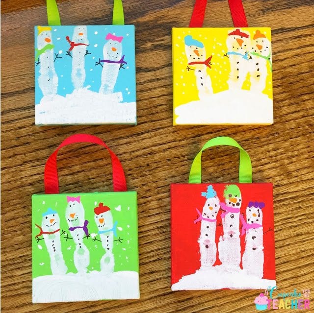 Four adorable painted scenes of snowmen made from fingerprings on canvas