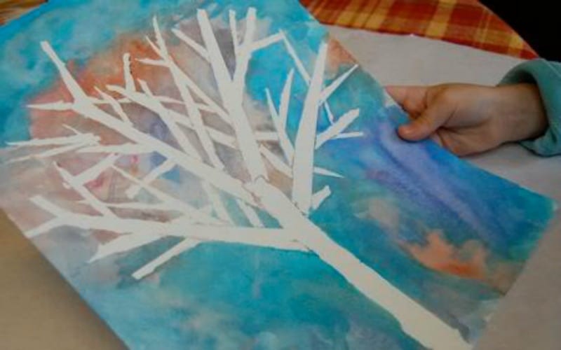 A beautiful white winter tree on a watercolor blue background as an example of classroom winter crafts