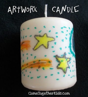 White pillar candle decorated with shooting stars