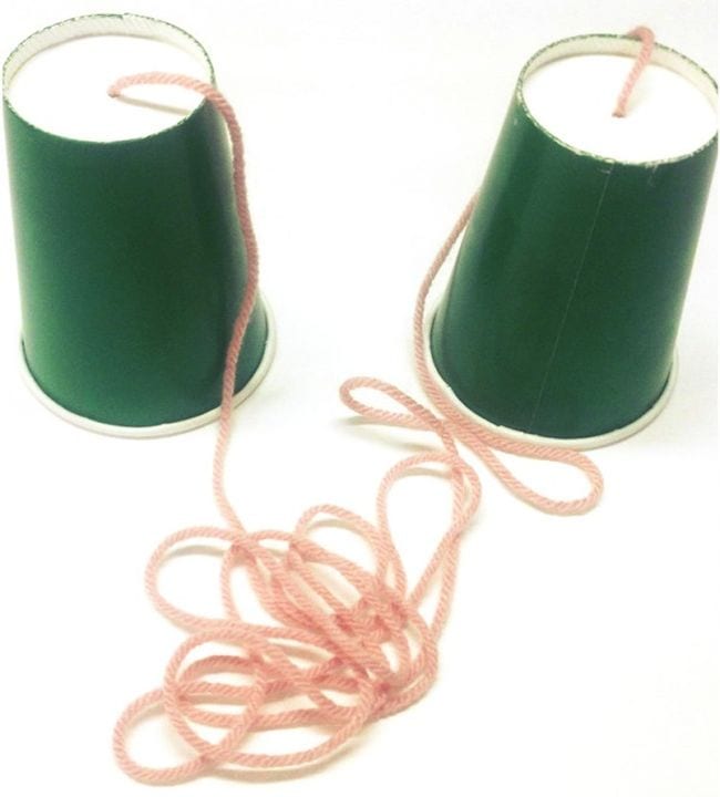 Two green paper cups connected at the bottoms by long pink string (First Grade Science Experiments)