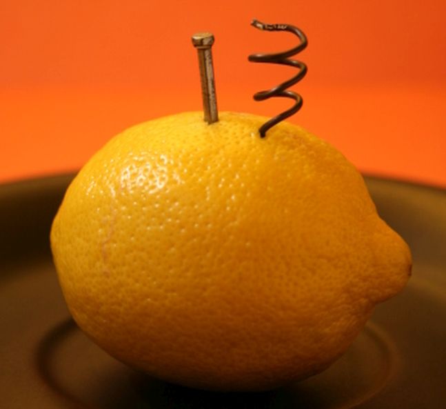 Lemon with a nail and a coil of wire stuck into it