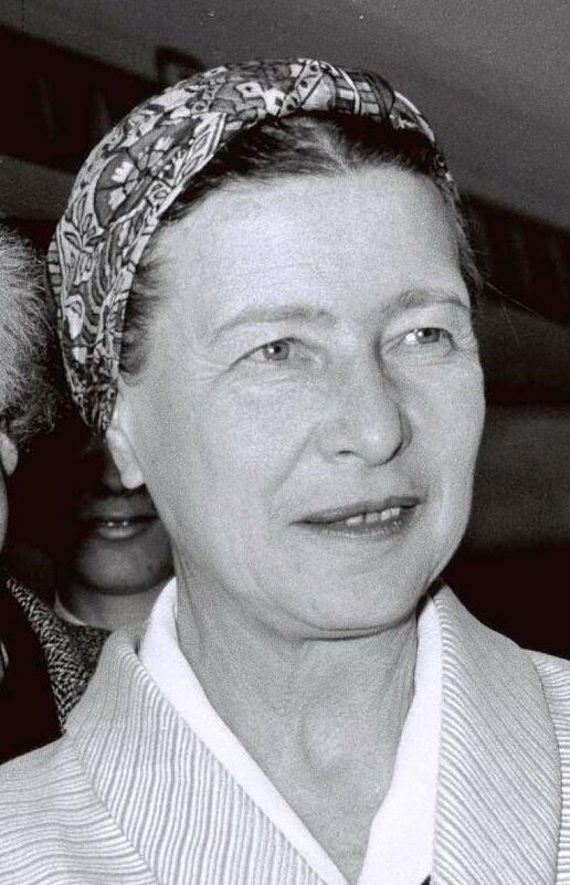 A middle aged woman is shown in a black and white photograph. Her hair is tied back with a bandana.