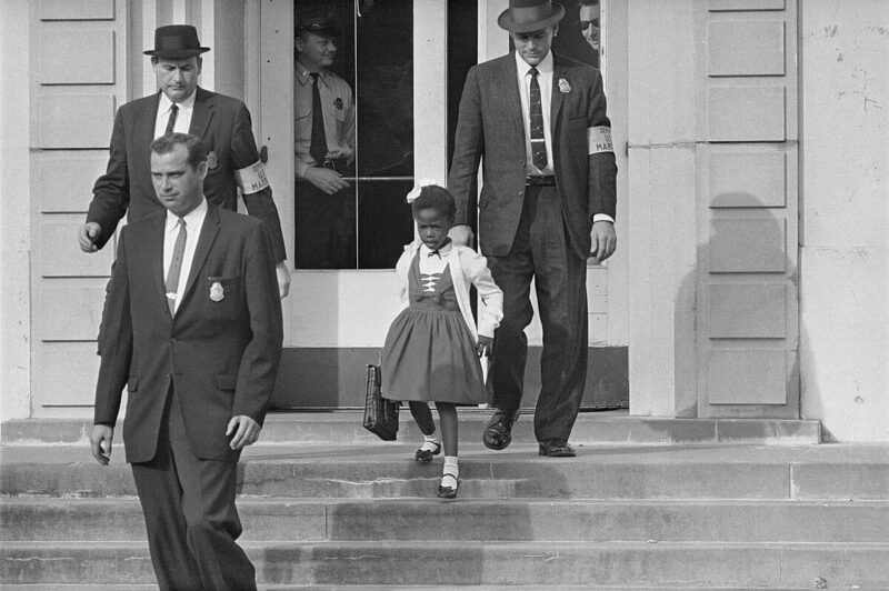 Young Ruby Bridges being escorted into an all-white school by U.S. Federal Marshals