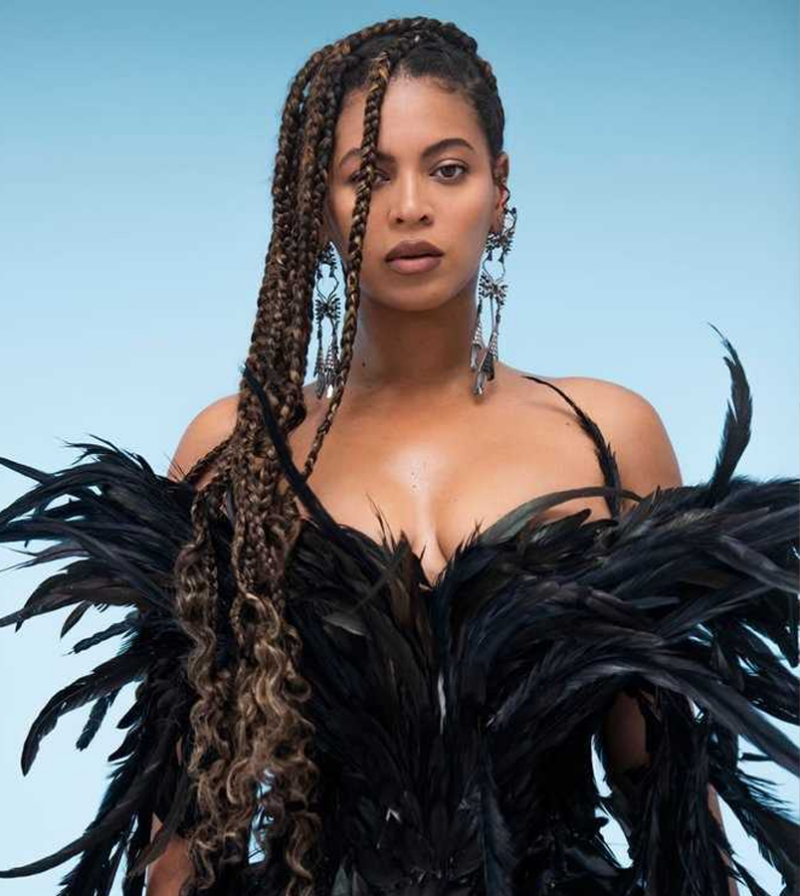 Beyonce in black feather dress with long braids