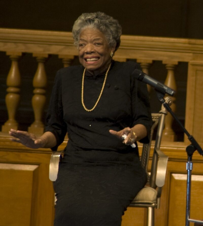 Maya Angelou on stage speaking,  an example of famous Black Americans everyone should know