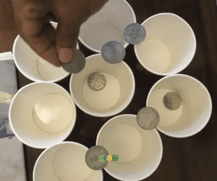 Coins being stacked on cups