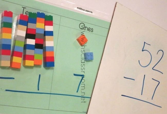 Stacks of legos on top of a double digit subtraction worksheet