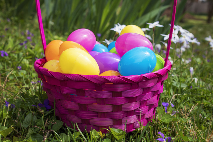 A purple basket filled with colorful plastic eggs is shown.