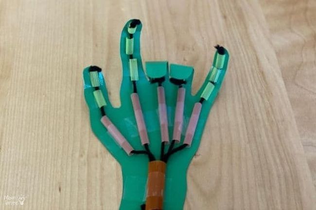 Model robotic hand made from paper, straws, and string