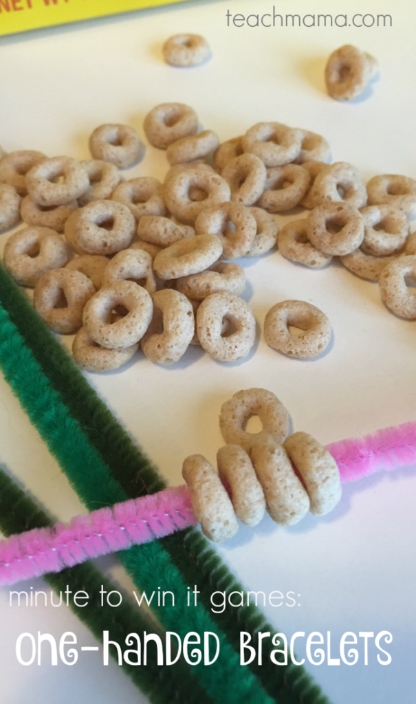 cheerios are being strung onto pipe cleaners.