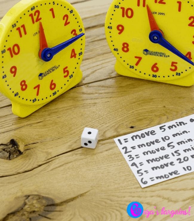 Two toy clocks and a notecard with the rules for the game that is an example of telling time games.