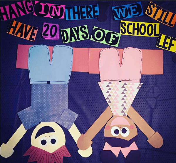 Bulletin board reads hang in there we still have 20 days of school left. Two kids are made from cardstock and are shown hanging upside down (summer bulletin boards ideas)