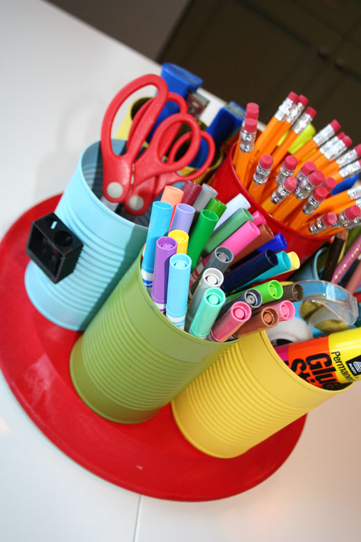 A colorful school supply caddy is built from recycled cans