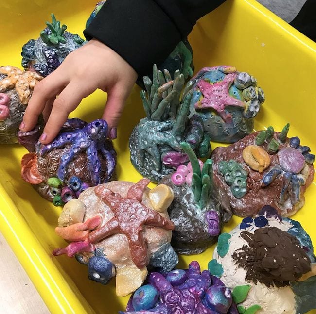Collection of clay sculptures of rocks with sea stars and urchins (Fourth Grade Art Projects)