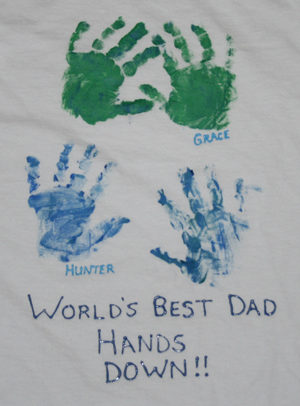 A shirt has children's fingerprints and names on it in this example of Father's Day crafts for kids.