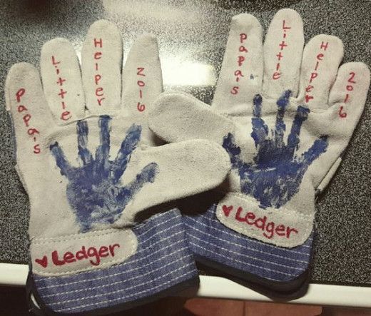 Worker gloves have paint handprints on them. 