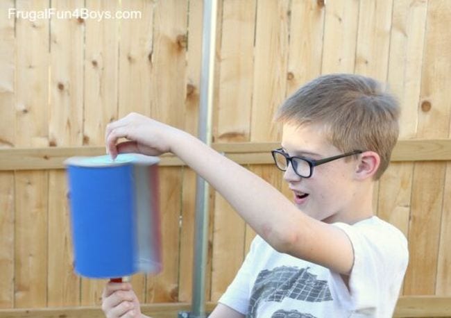 Child playing with a DIY wind turbine