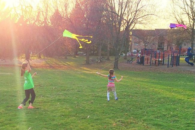 Children flying homemade kites in the evening
