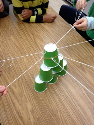 Green paper cups with strings attached stacked on a table as example of job readiness skills