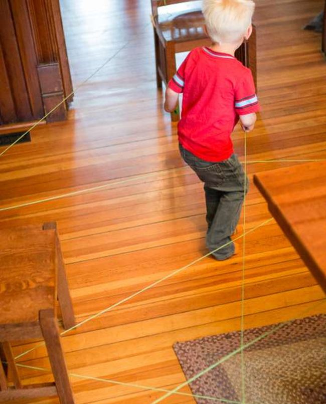 Child following a string obstacle course maze