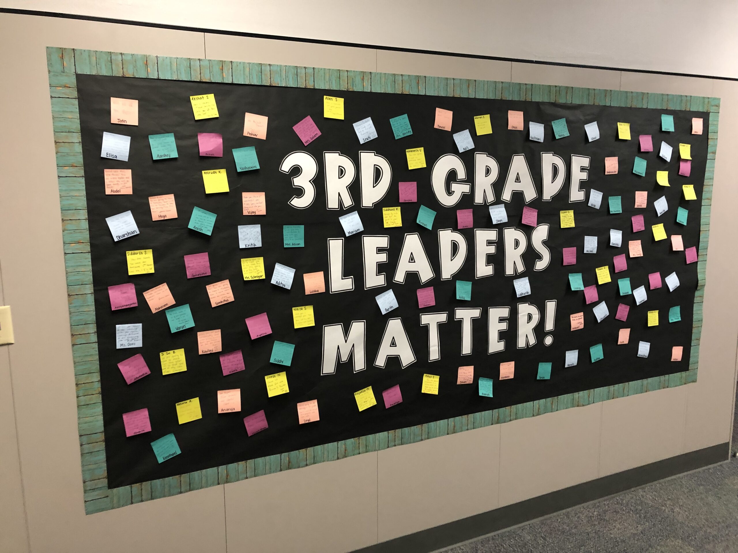 A black bulletin board says 3rd grade leaders matter. It has post its from kids all over it.