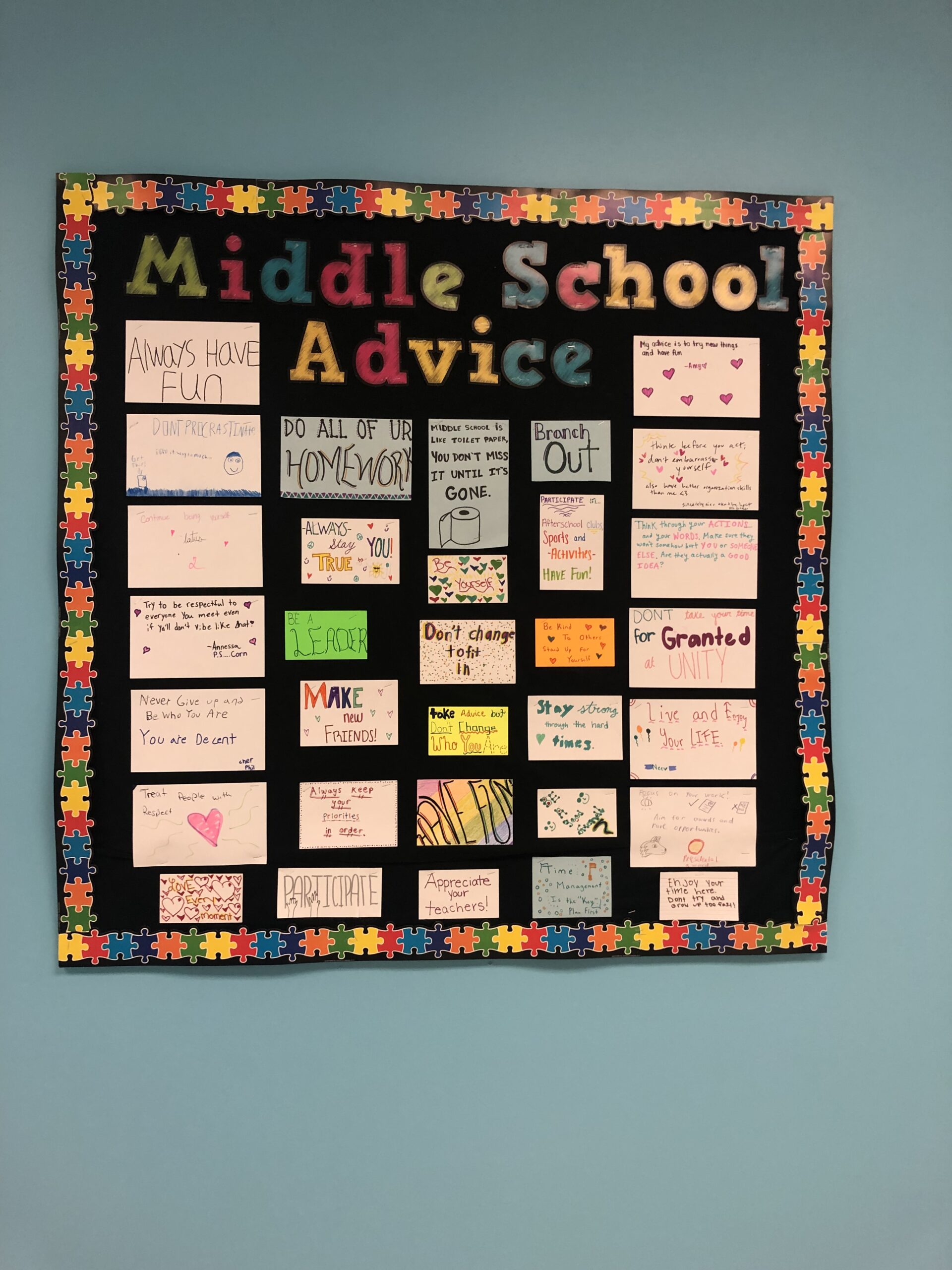 A Board says Middle School Advice and has papers written by kids on it.