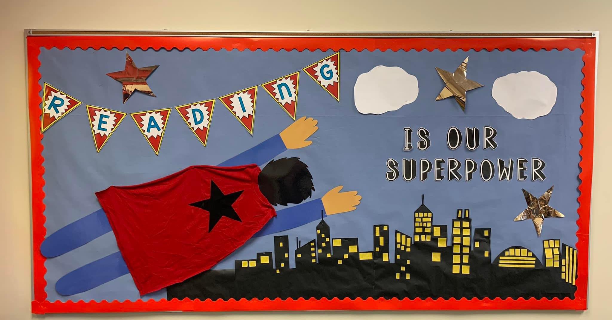 A bulletin board shows superman flying across it and says Reading is my Superpower.