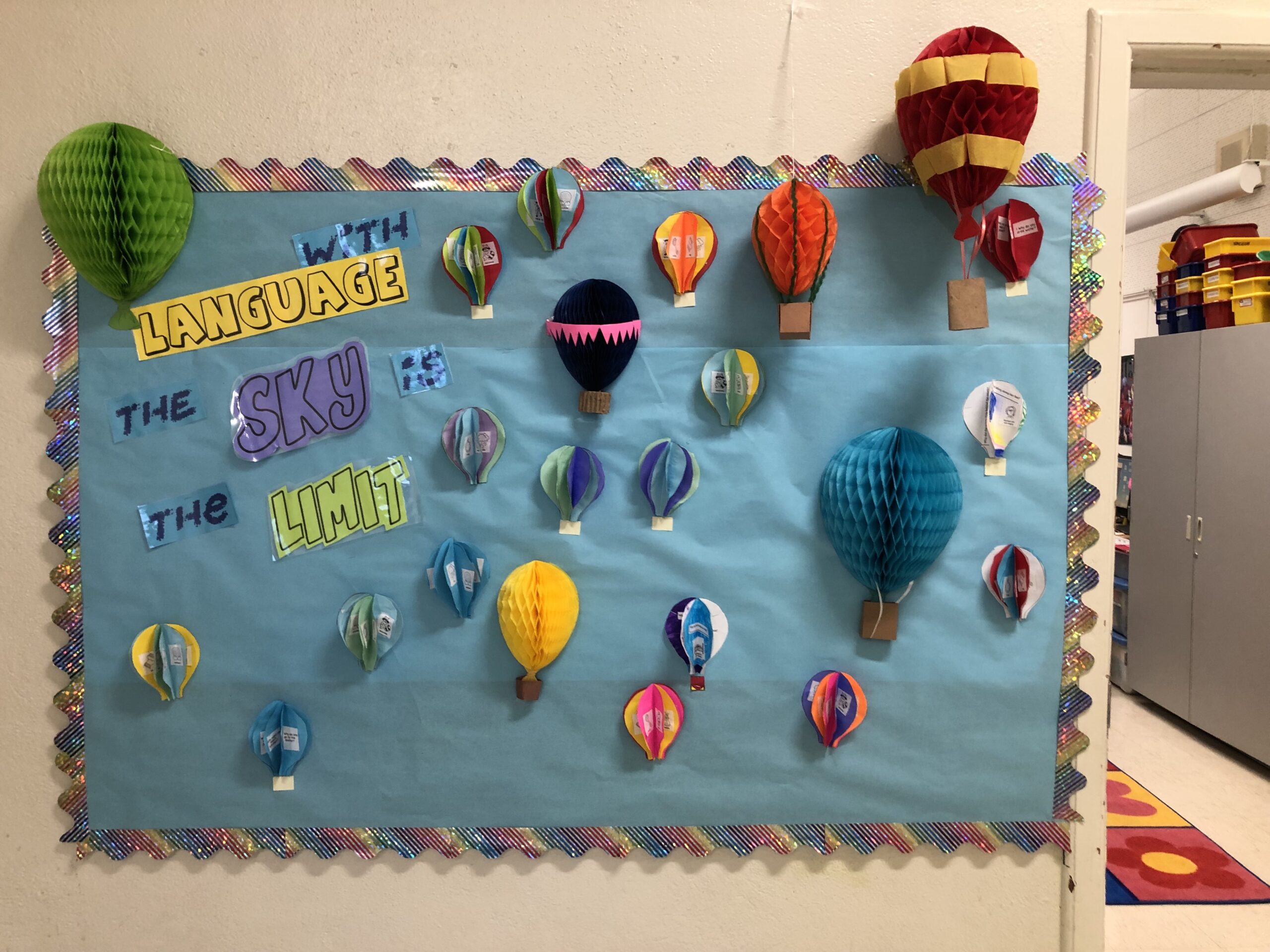 3-D hot air balloons decorate a bulletin board.